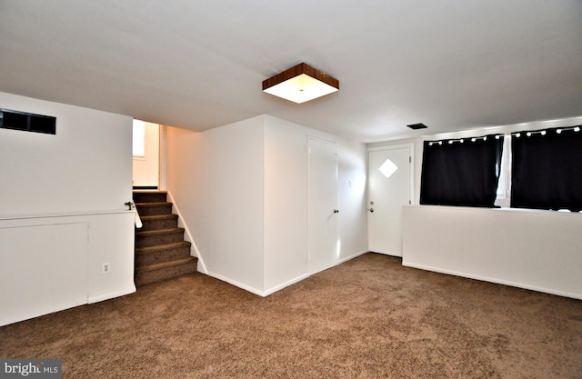 interior space featuring dark colored carpet