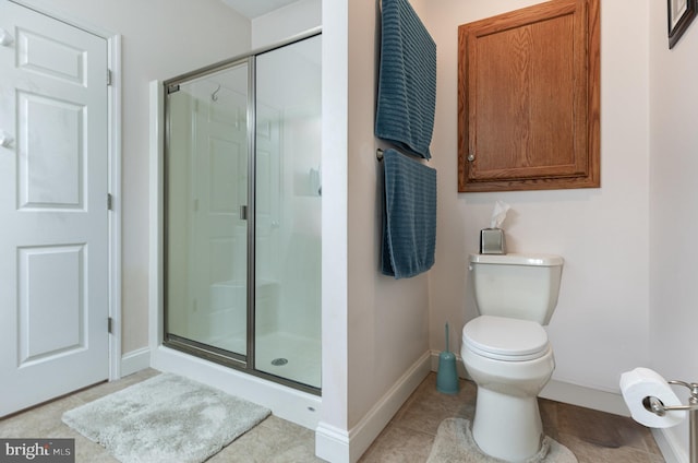 bathroom featuring walk in shower, tile patterned floors, and toilet