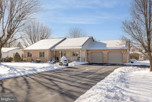 ranch-style home with a porch and a garage