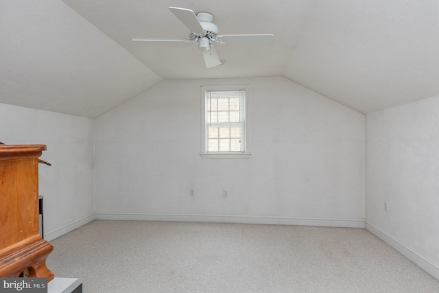 additional living space featuring lofted ceiling, light carpet, and ceiling fan