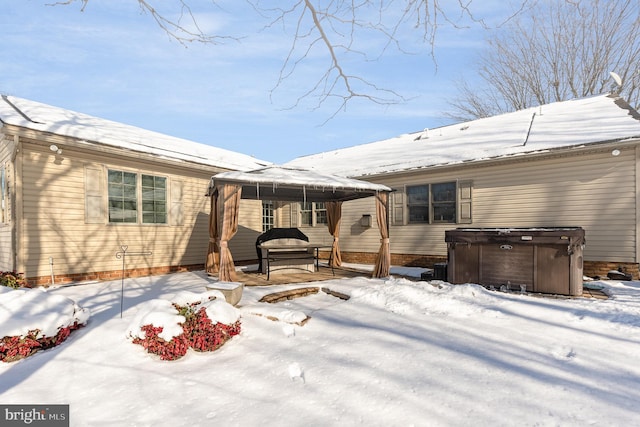 snow covered patio with a hot tub