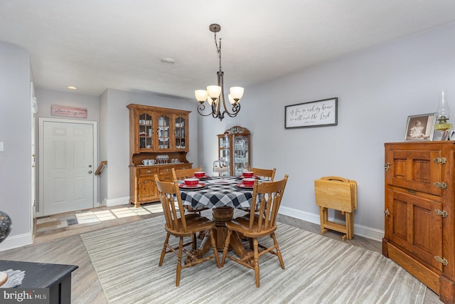 dining area with a chandelier and light wood-type flooring