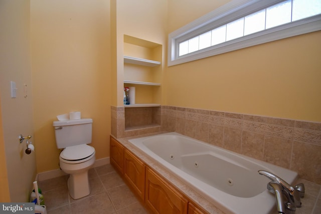 bathroom with built in shelves, a tub, tile patterned floors, and toilet