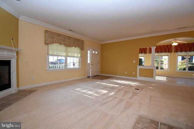 unfurnished living room featuring light carpet, crown molding, decorative columns, and ceiling fan