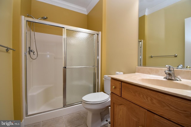 bathroom featuring crown molding, a shower with door, vanity, tile patterned floors, and toilet