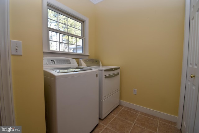 washroom with light tile patterned floors and washing machine and clothes dryer