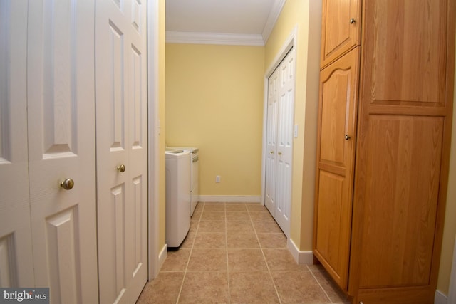 washroom with light tile patterned floors, washer and clothes dryer, and ornamental molding