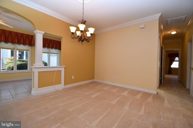 carpeted spare room with crown molding, decorative columns, and a notable chandelier