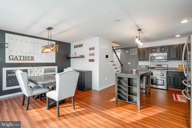 dining space with hardwood / wood-style floors