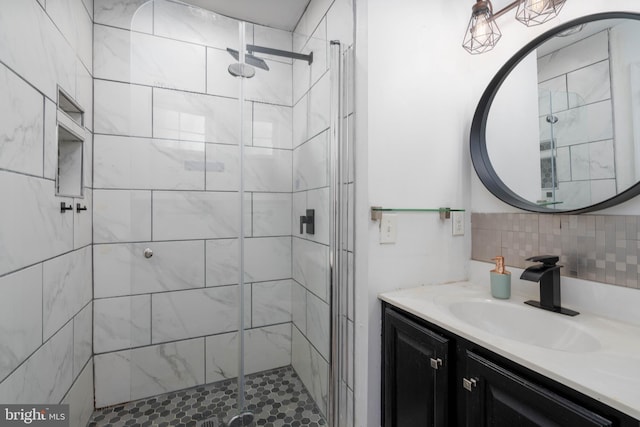 bathroom with a shower with door, backsplash, and vanity