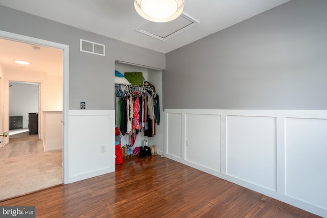 bedroom with a closet and dark hardwood / wood-style floors