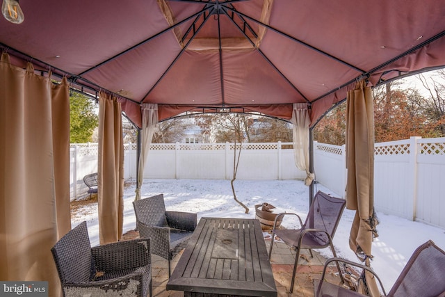 snow covered patio featuring a gazebo