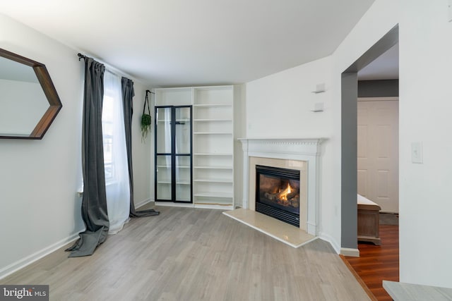 unfurnished living room with light hardwood / wood-style floors