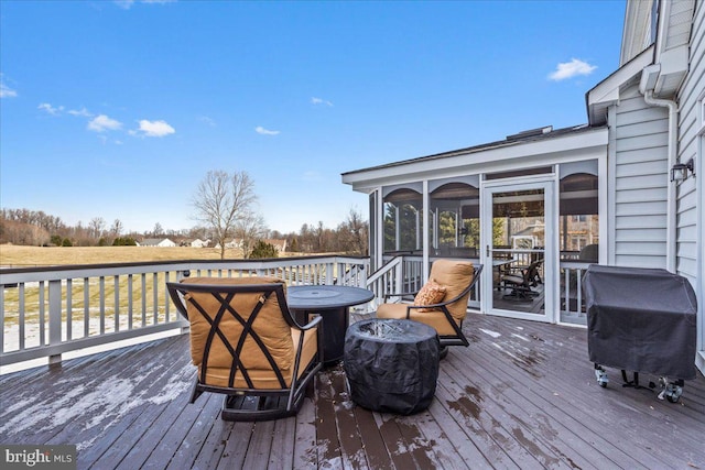 wooden deck featuring area for grilling and a sunroom