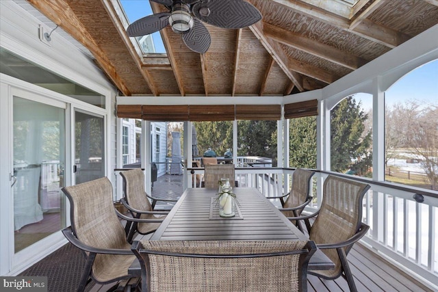 sunroom / solarium featuring ceiling fan and lofted ceiling with skylight