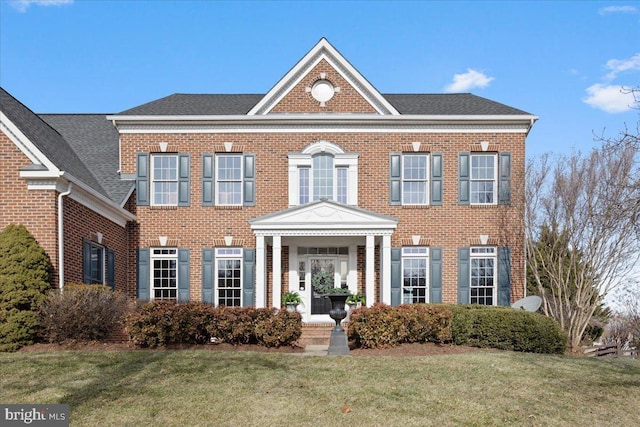 colonial inspired home featuring a front yard