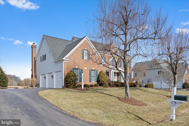 view of front facade with a garage and a front yard