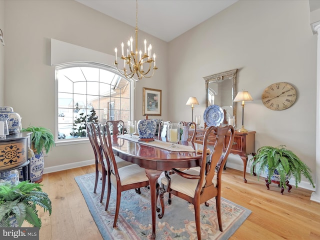 dining space featuring an inviting chandelier and light hardwood / wood-style floors