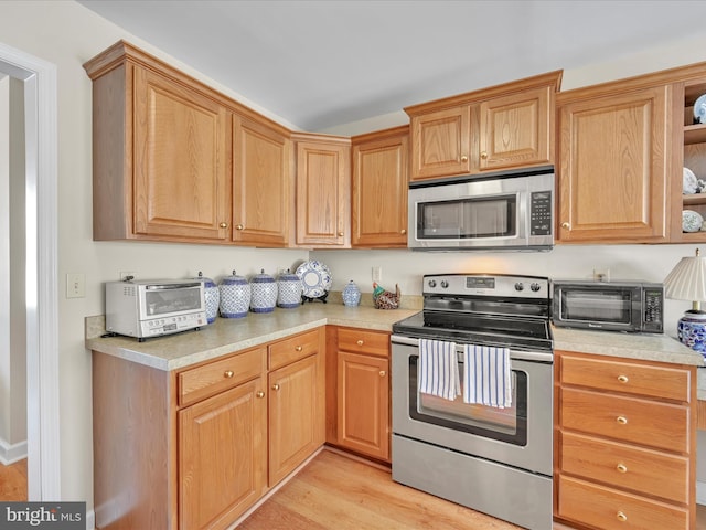 kitchen with appliances with stainless steel finishes and light wood-type flooring