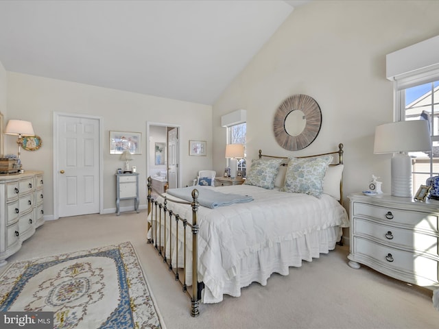 bedroom with light colored carpet and high vaulted ceiling