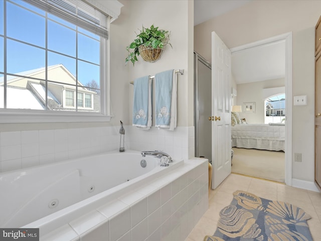 bathroom featuring tile patterned floors and tiled bath