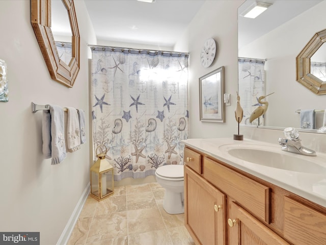 bathroom featuring vanity, toilet, and curtained shower