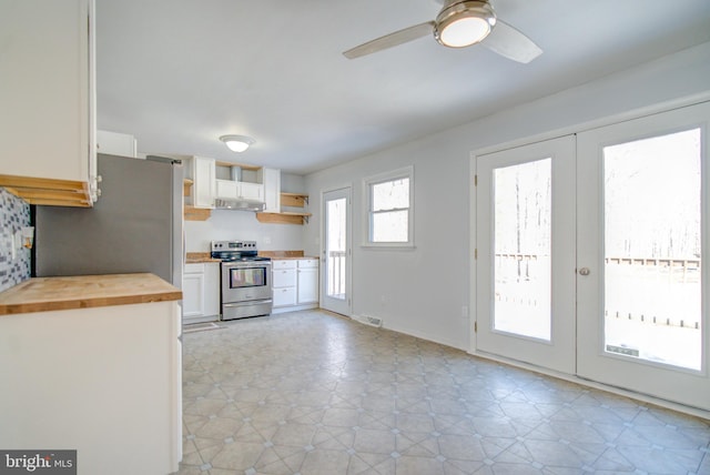 kitchen featuring french doors, white cabinetry, wooden counters, electric range, and ceiling fan