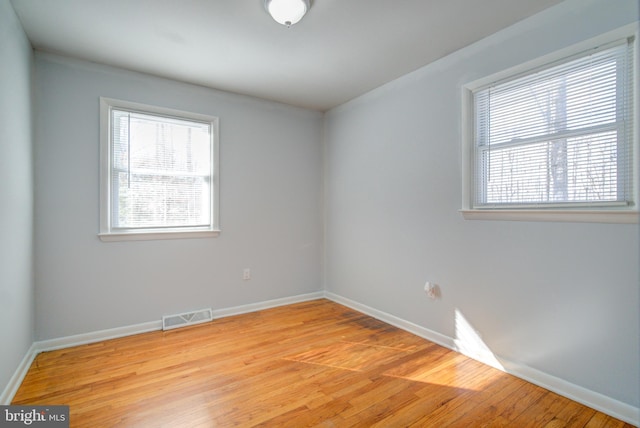 spare room featuring light hardwood / wood-style floors