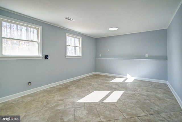 empty room featuring crown molding