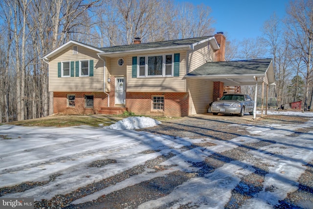 split foyer home featuring a carport