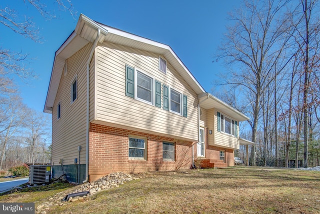 exterior space with cooling unit and a front yard