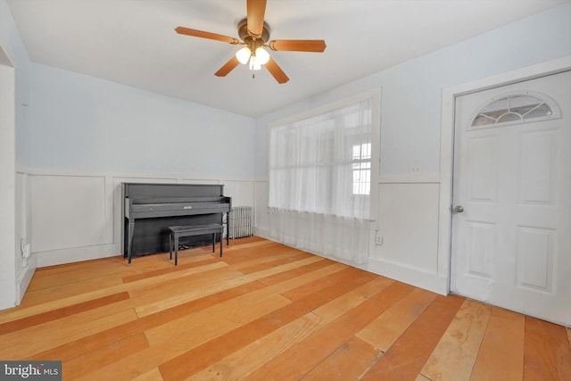 miscellaneous room featuring ceiling fan, hardwood / wood-style floors, and radiator heating unit