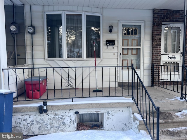 view of snow covered property entrance