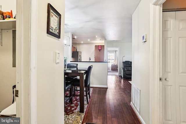 corridor with dark hardwood / wood-style floors