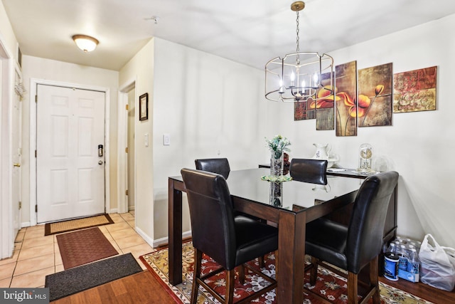 tiled dining space with a chandelier