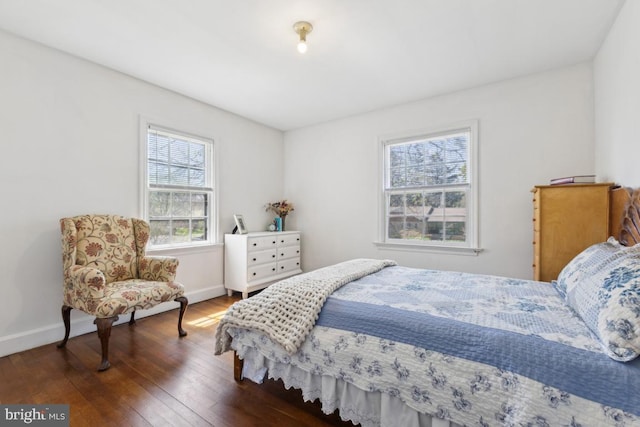 bedroom featuring hardwood / wood-style flooring and baseboards