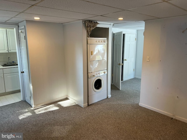 laundry room with stacked washer / dryer, sink, and light carpet