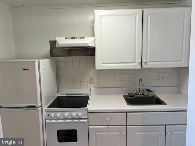 kitchen with white cabinetry, sink, white appliances, and tasteful backsplash