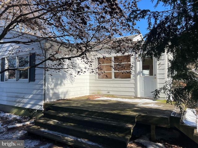 view of side of home with a wooden deck