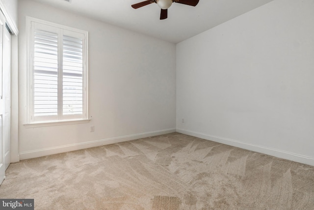 carpeted empty room with ceiling fan