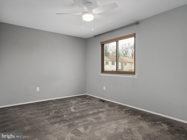 carpeted empty room featuring ceiling fan