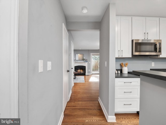 kitchen featuring white cabinetry and wood-type flooring