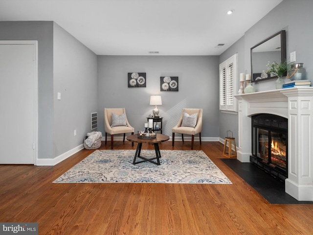 sitting room featuring dark hardwood / wood-style flooring