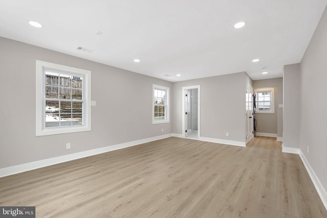 empty room with light hardwood / wood-style floors