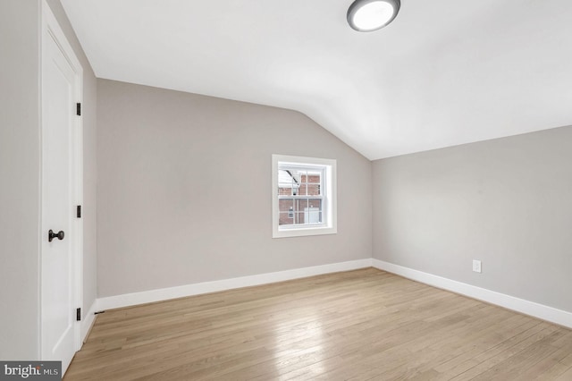 bonus room featuring light hardwood / wood-style flooring and lofted ceiling