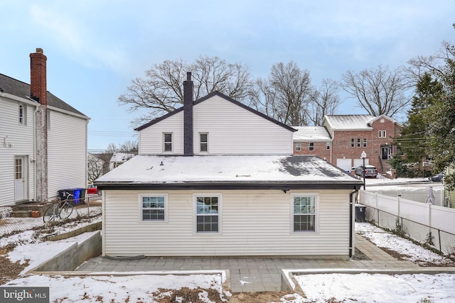 snow covered property featuring cooling unit