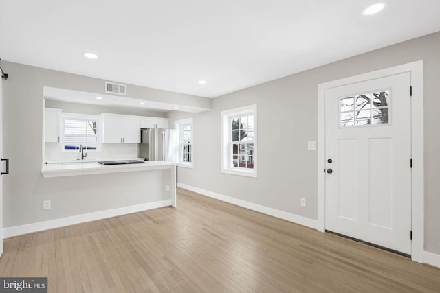 foyer with sink and light wood-type flooring