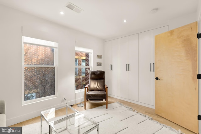 sitting room with light hardwood / wood-style flooring