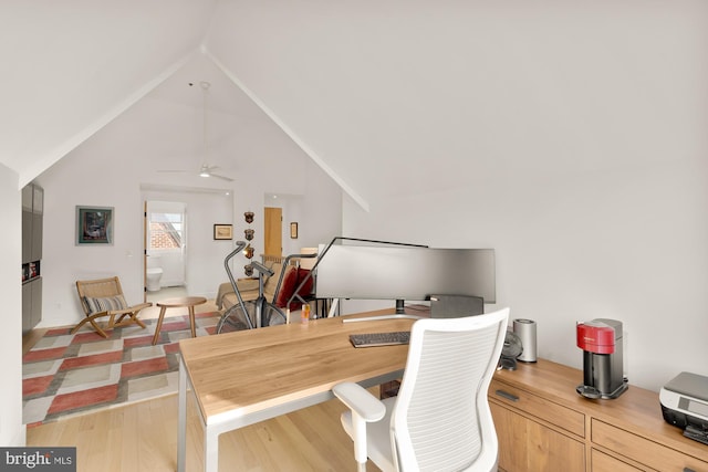 office space featuring ceiling fan, lofted ceiling, and light hardwood / wood-style flooring