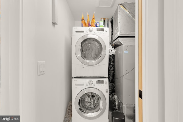 washroom featuring stacked washer / drying machine